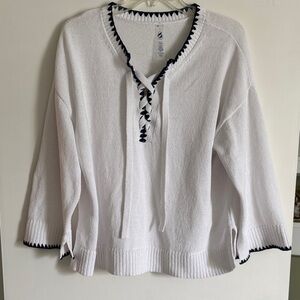 White sweater with navy stitching